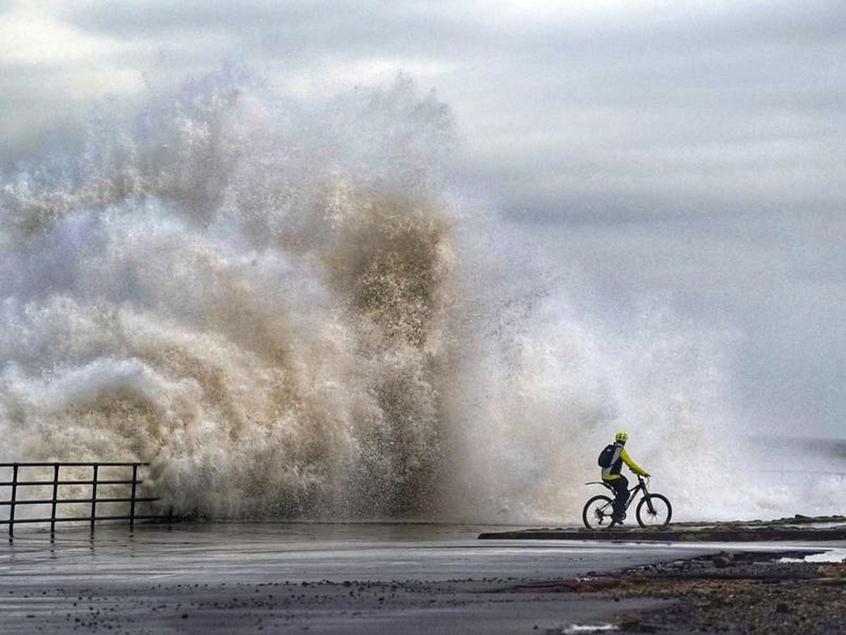 Flooding feared as heavy rain and strong gusts hit parts of UK